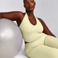SoftMotion™ Halter Neck Mid Tank Top with Built in Bra Shelf with Gray Logo | Pastel Yellow