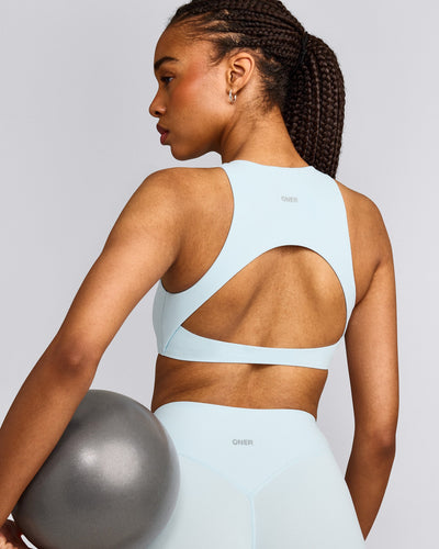 SoftMotion™ High Neck Sports Bra with Grey Logo |  Cloud Blue
