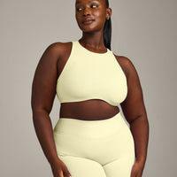 SoftMotion™ High Neck Sports Bra with Grey Logo | Pastel Yellow