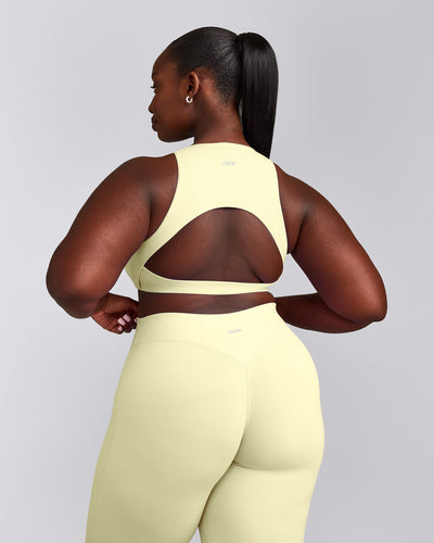 SoftMotion™ High Neck Sports Bra with Gray Logo | Pastel Yellow