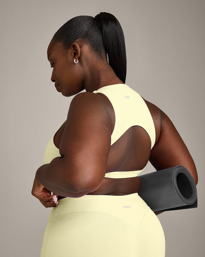 SoftMotion™ High Neck Sports Bra with Grey Logo | Pastel Yellow