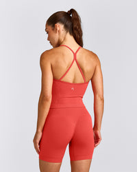 EnhanceLift™ Seamless Strappy Racer Tank Top with Built in Bra Shelf with Gray Logo | Dark Charged Coral