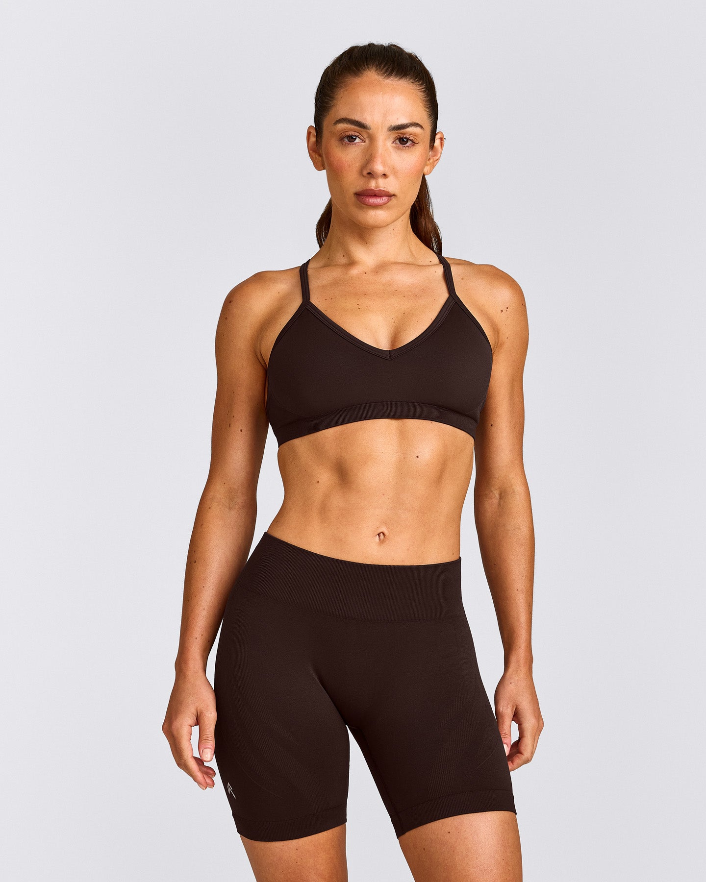 EnhanceLift™ Seamless Strappy Sports Bra with Gray Logo | 70% Cocoa
