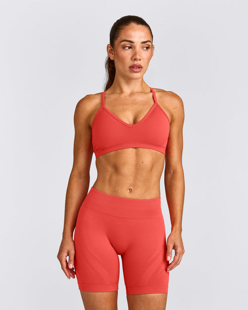 EnhanceLift™ Seamless Strappy Sports Bra with Gray Logo | Dark Charged Coral
