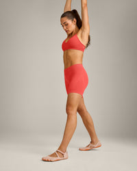 EnhanceLift™ Seamless Strappy Sports Bra with Grey Logo | Dark Charged Coral