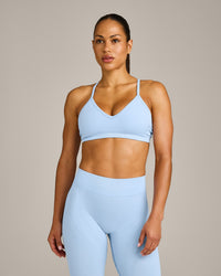 EnhanceLift™ Seamless Strappy Sports Bra with Grey Logo | Powdered Blue