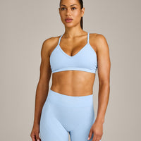EnhanceLift™ Seamless Strappy Sports Bra with Grey Logo | Powdered Blue