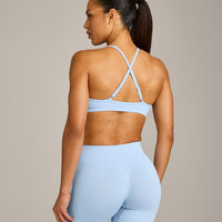 EnhanceLift™ Seamless Strappy Sports Bra with Grey Logo | Powdered Blue