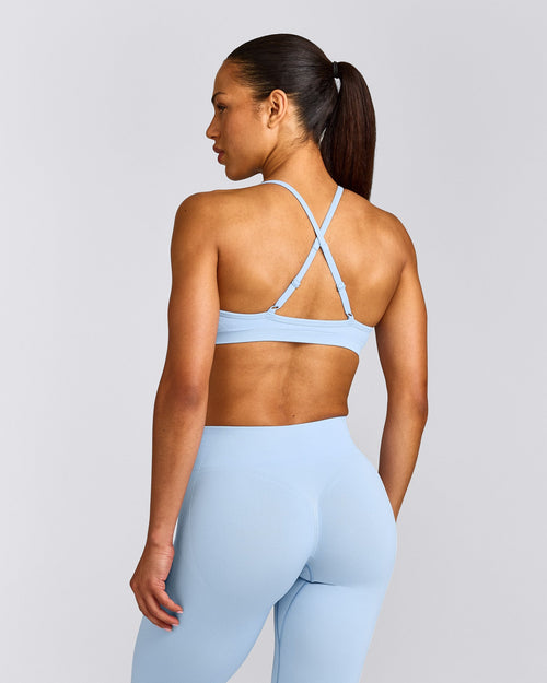 EnhanceLift™ Seamless Strappy Sports Bra with Gray Logo | Powdered Blue