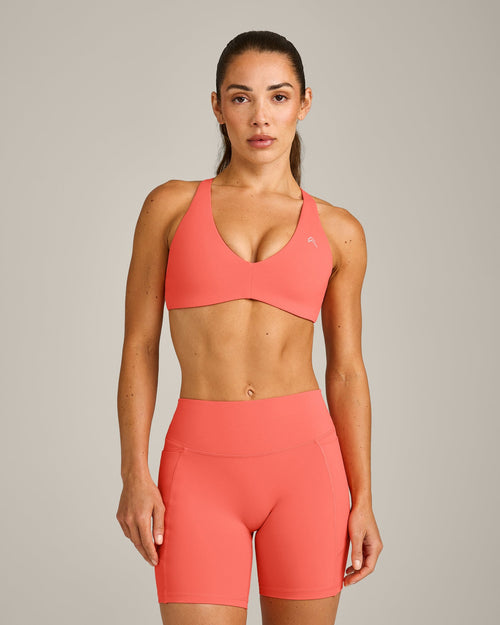 UnifiedMove™ Cross Back Sports Bra with Reflective Logo | Light Charged Coral