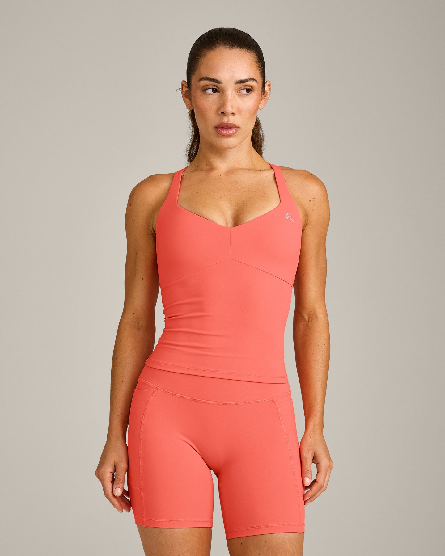 UnifiedMove™ T Back Mid Vest with Built in Bra Shelf with Reflective Logo | Light Charged Coral