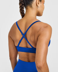 EnhanceLift™ Seamless Strappy Sports Bra with White Logo | Cobalt Blue